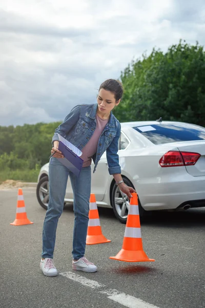 Attractive Woman Holding Car Insurance Putting Traffic Cones Road — стоковое фото